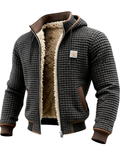 Arkadya Outlet Lekka Kurtka Pikowana Męska Luźny Krój Wysoki Kołnierz to stylowa czarna kurtka pikowana męska z brązowymi wykończeniami, puszystą beżową podszewką, kapturem, zapięciem na suwak, bocznymi kieszeniami, wysokim kołnierzem i naszywką na piersi.