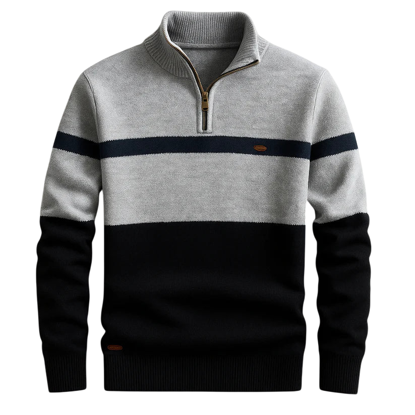 Męski sweter Arkadya Outlet to lekki, dzianinowy sweter z długimi rękawami i zapięciem na zamek błyskawiczny, charakteryzujący się blokami kolorystycznymi: jasnoszarym na górze, granatowym na piersi i czarnym w dolnej części ciała i na rękawach.