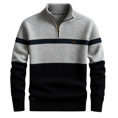 Męski sweter Arkadya Outlet to lekki, dzianinowy sweter z długimi rękawami i zapięciem na zamek błyskawiczny, charakteryzujący się blokami kolorystycznymi: jasnoszarym na górze, granatowym na piersi i czarnym w dolnej części ciała i na rękawach.