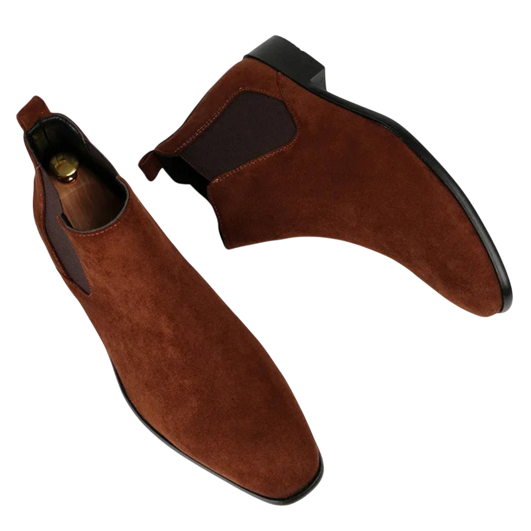 Botki męskie wsuwane z kwadratowym noskiem i niskim obcasem marki Arkadya Outlet z brązowego zamszu, z czarnymi podeszwami, elastycznymi panelami bocznymi i zakładkami, prezentowane na białym tle.