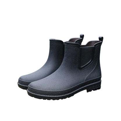 Para Arkadya Outlet Buty Chelsea męskie zimowe wsuwane antypoślizgowe w kolorze czarnym z teksturowanymi podeszwami i elastycznymi panelami bocznymi, pokazane na gładkim białym tle.