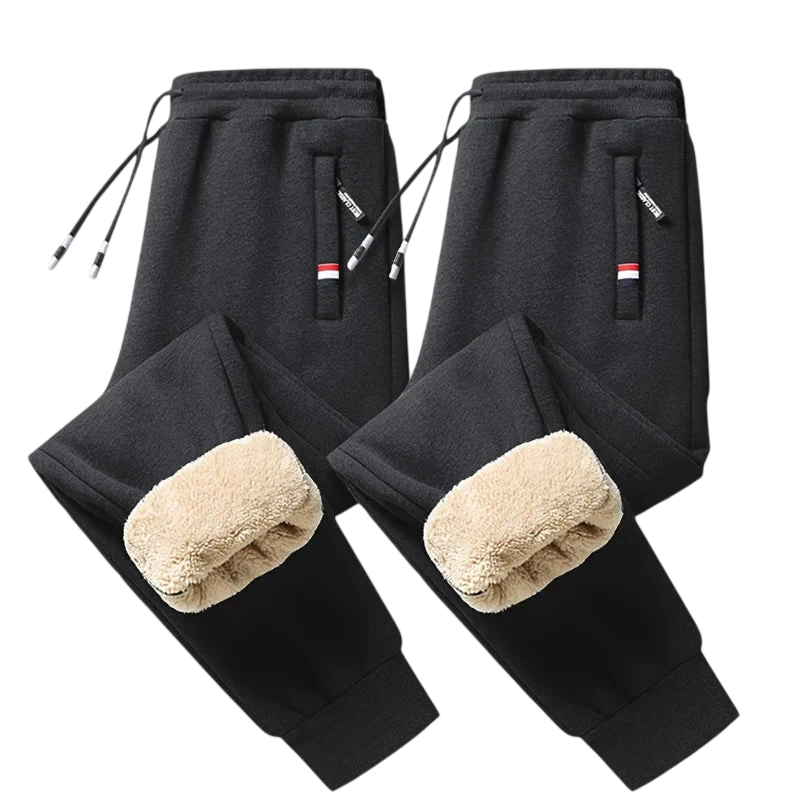 Dwie pary czarnych Arkadya Outlet Spodnie Termiczne Męskie Elastyczny Pas Z Regulacją W Talii z beżowymi puszystymi wnętrzami są pokazane na jasnoszarym tle. Każda z nich ma zapinane na zamek kieszenie w paski i sznurki ściągające - idealne na chłodne dni.