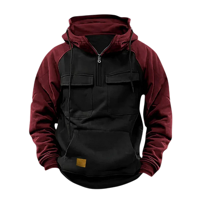 Arkadya Outlet Męska Bluza to dwukolorowa bluza z kapturem z czarnym korpusem, bordowymi rękawami i kapturem, pół-zamkiem z przodu, dwiema kieszeniami na piersi i dużą przednią kieszenią z małą brązową naszywką.