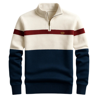 Sweter Arkadya Outlet Męski to kolorowy sweter z długim rękawem, kremową górą, bordowym paskiem na piersi i granatową dolną częścią. Posiada zapinany do połowy kołnierz i małą okrągłą naszywkę na lewej piersi.