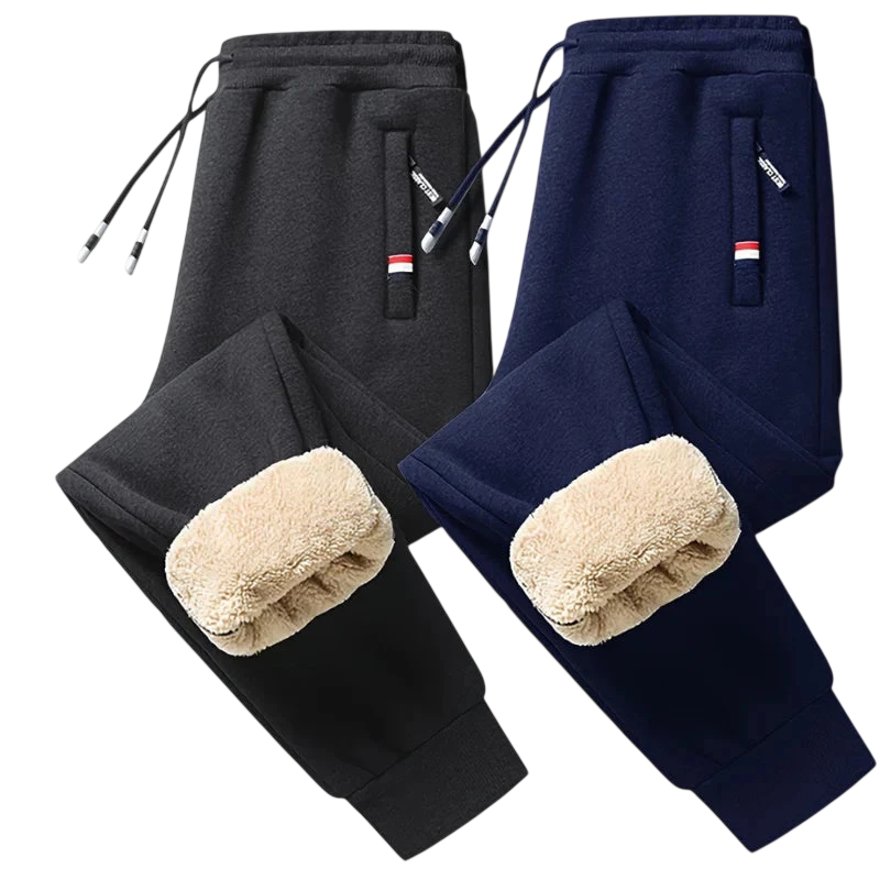 Dwie pary Arkadya Outlet Spodnie Termiczne Męskie Elastyczny Pas Z Regulacją W Talii - jedna czarna, druga granatowa - z kieszeniami zapinanymi na zamek i kostkami wyściełanymi polarem, idealne na chłodne dni, prezentowane na jasnoszarym tle.