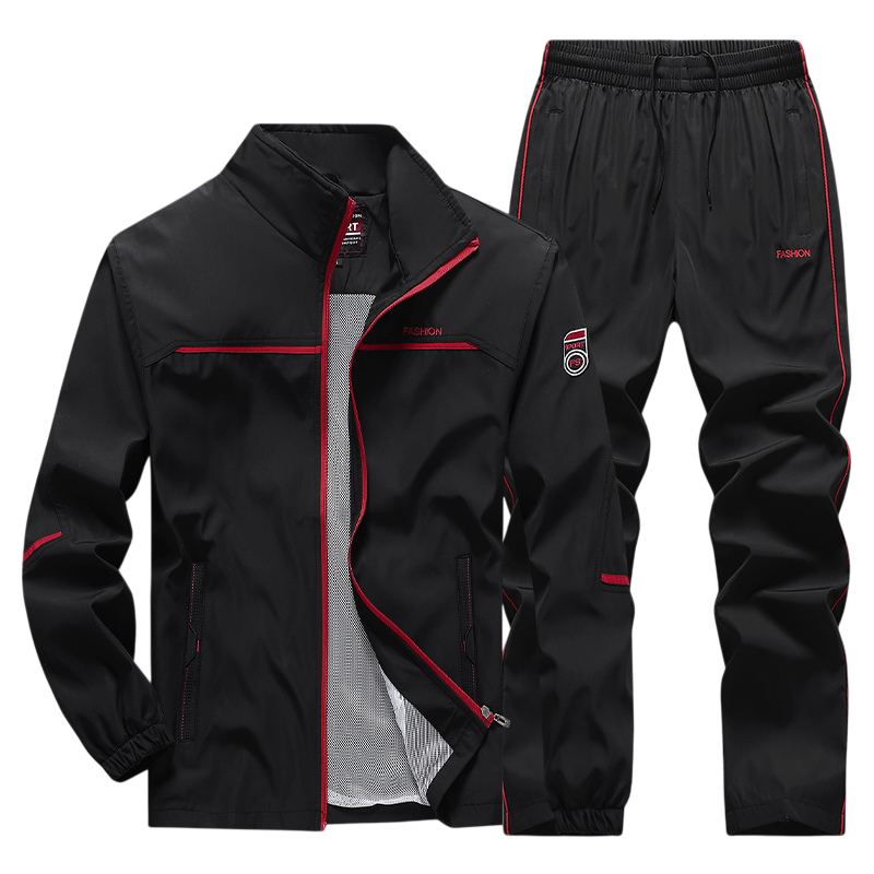 Arkadya Outlet Dres komplet męski dwuczęściowy: czarny zestaw z czerwonymi akcentami, bluza na zamek ze stójką i spodnie na gumce, oba z napisem FASHION na piersi i udzie.